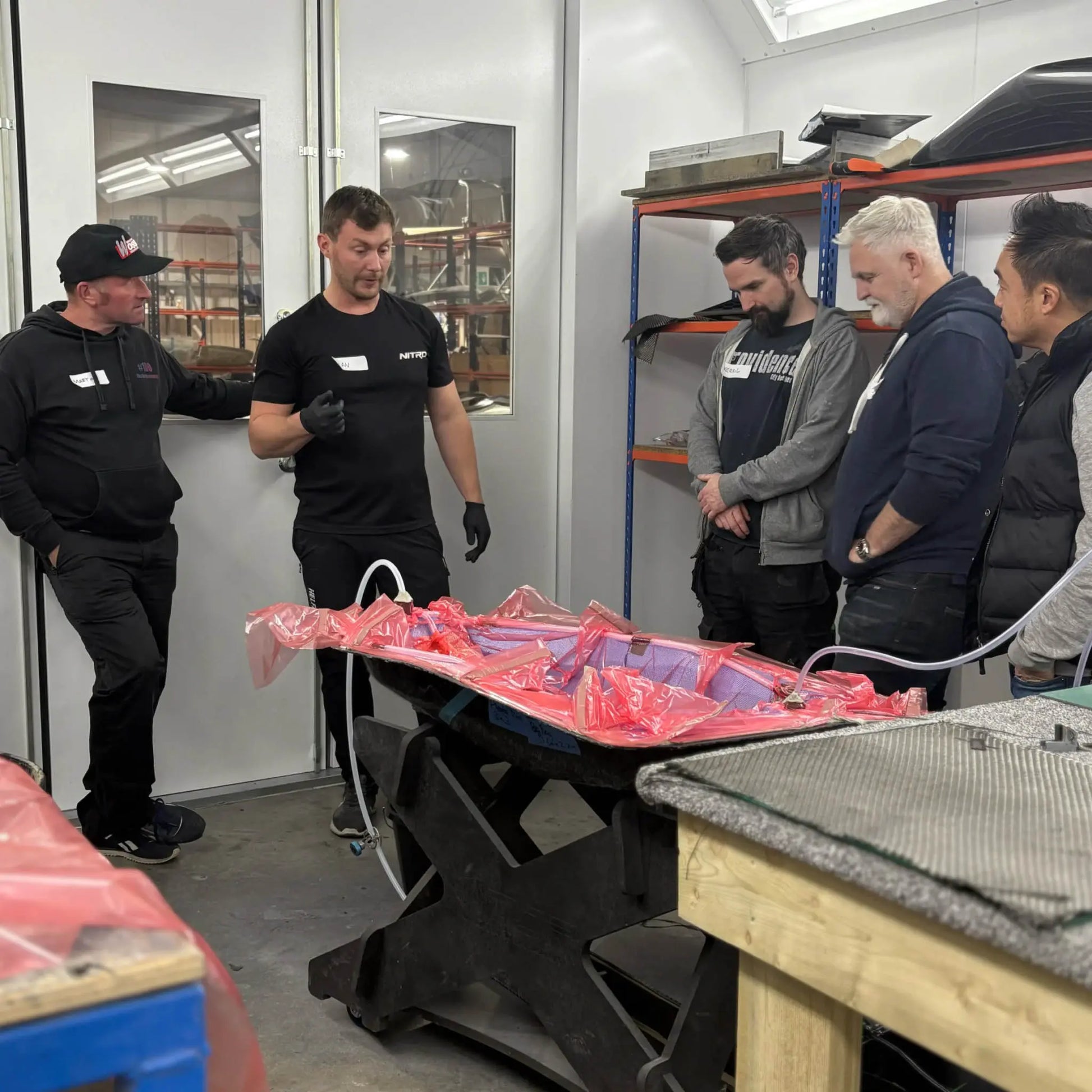 Hands-on carbon fibre training course in the UK demonstrating vacuum resin infusion techniques with instructor guidance.